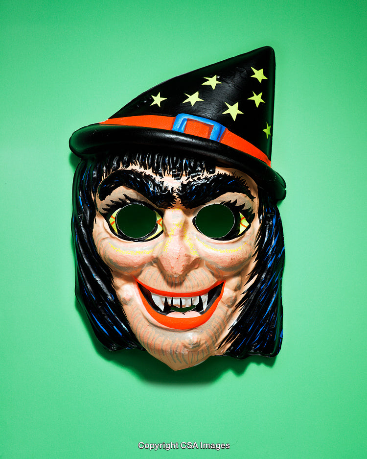 Colorful Witch Mask With Halloween Hat Over Green Background