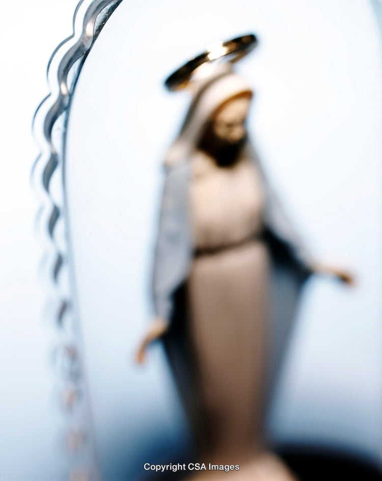 Blurred Religious Statue with Halo and Soft Blue Background