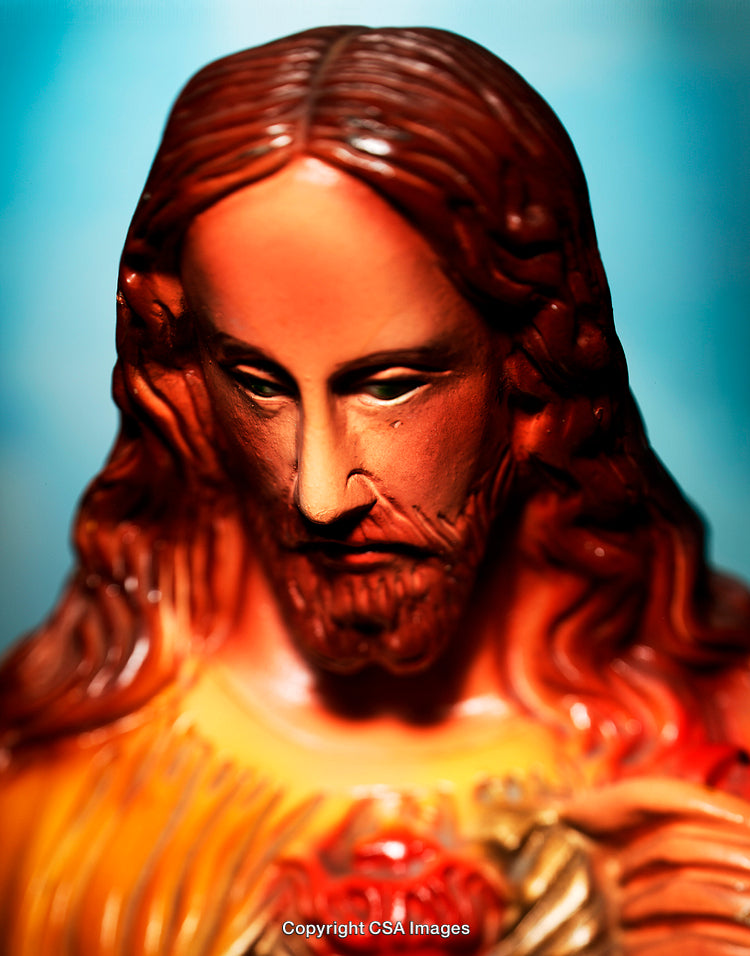 Close-Up of a Religious Figurine with Focused Expression and Warm Lighting