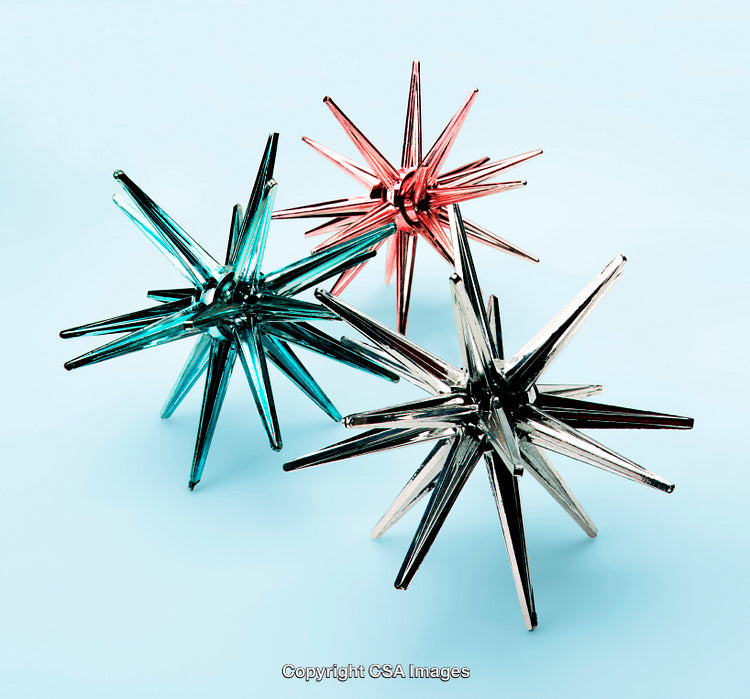 Colorful Geometric Star-Shaped Plastic Toys Against a Light Blue Background