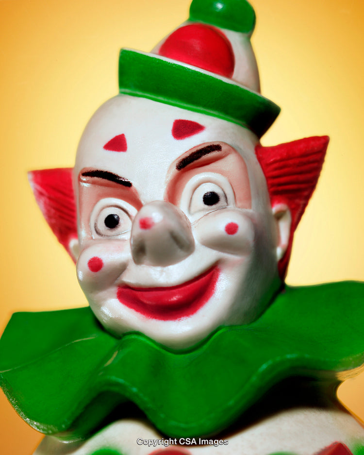 Colorful Clown Figurine Close-Up on Vibrant Yellow Background