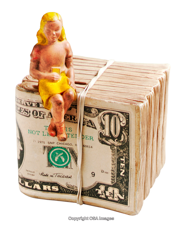 Plastic Figure Sitting on a Stack of Bound Ten Dollar Bills