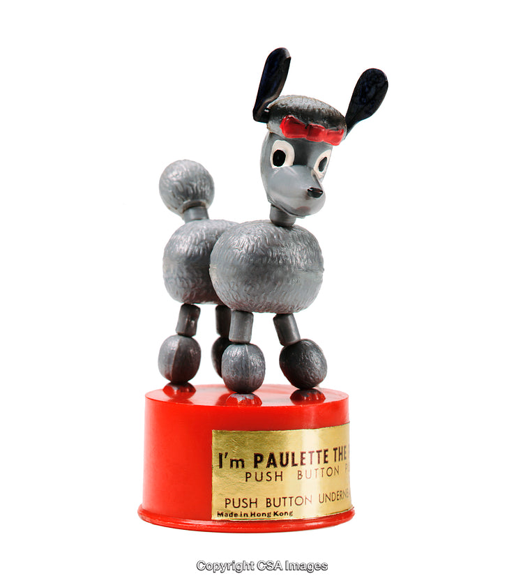 Vintage Retro Toy Figurine of a Cartoon Styled Poodle on Red Base