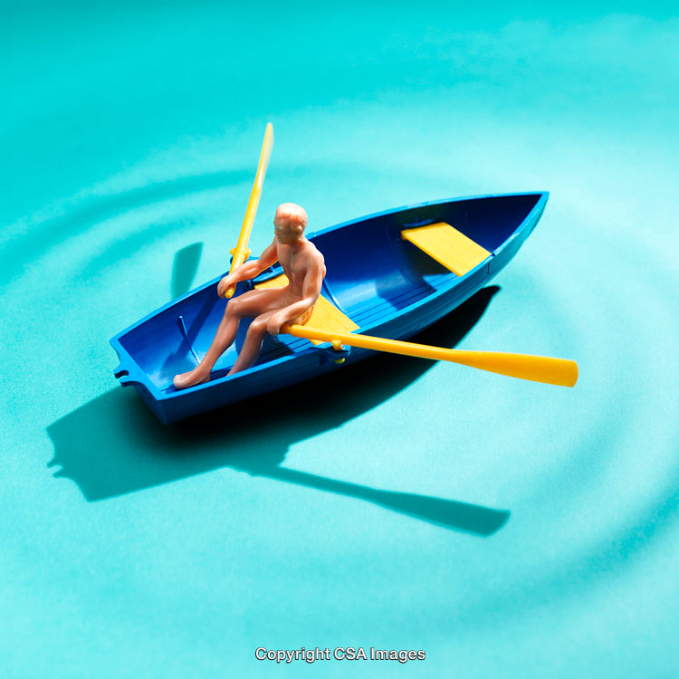Miniature Figure Rowing a Blue Boat on Turquoise Background