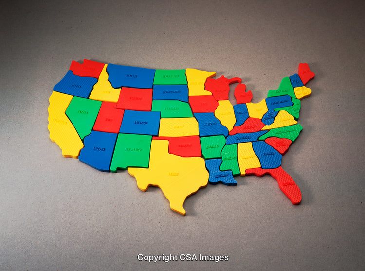 Colorful Plastic United States Map Puzzle on a Gray Surface