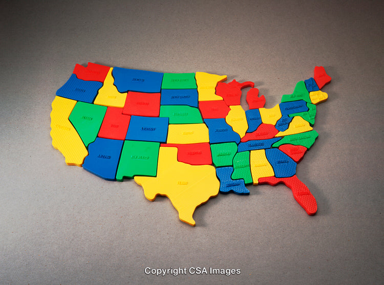 Colorful Plastic United States Map Puzzle on a Gray Surface
