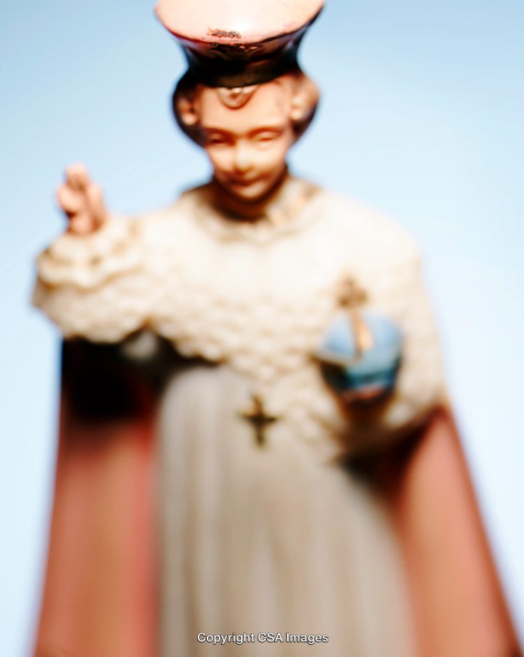 Close-Up of Religious Figurine with Pastel Tones on Blue Background