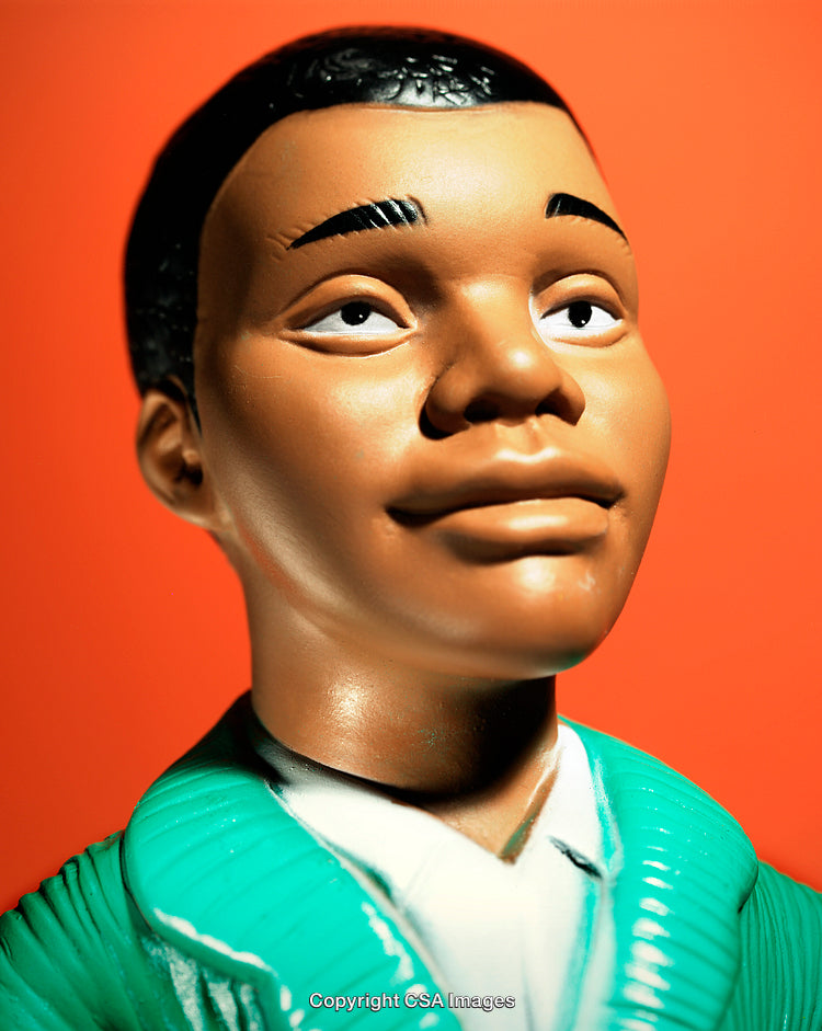 Close-Up of a Toy Figure Against an Orange Background