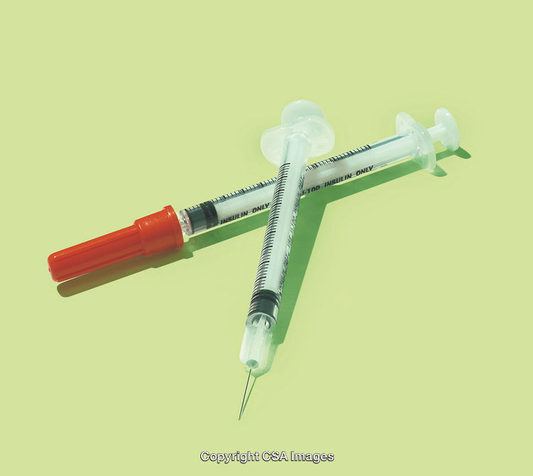 Sterile Insulin Syringes Crossed with Bright Green Background