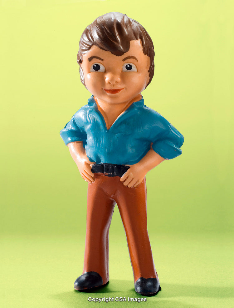 Colorful Plastic Male Figurine on Vibrant Green Background