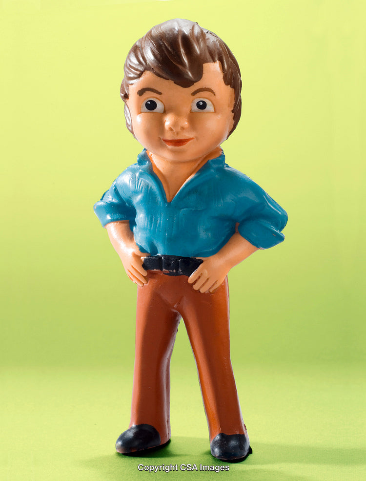 Colorful Plastic Male Figurine on Vibrant Green Background