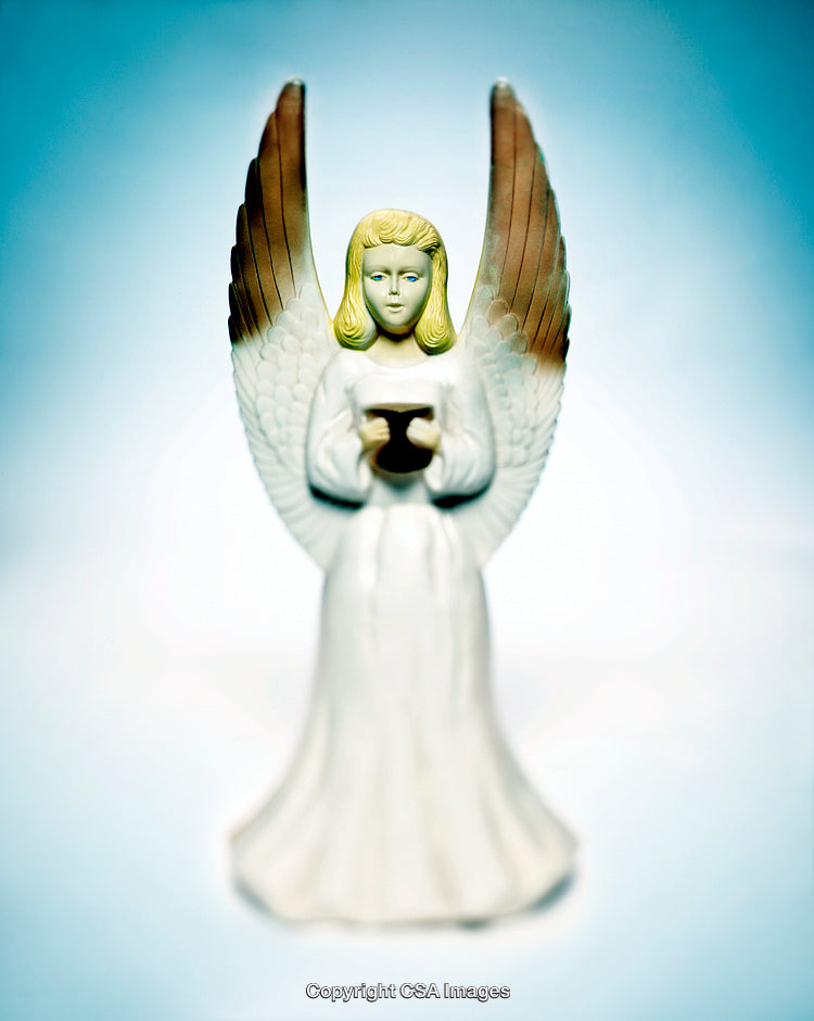 Elegant Angel Figurine on Blue Background with Wings Spread in Serenity