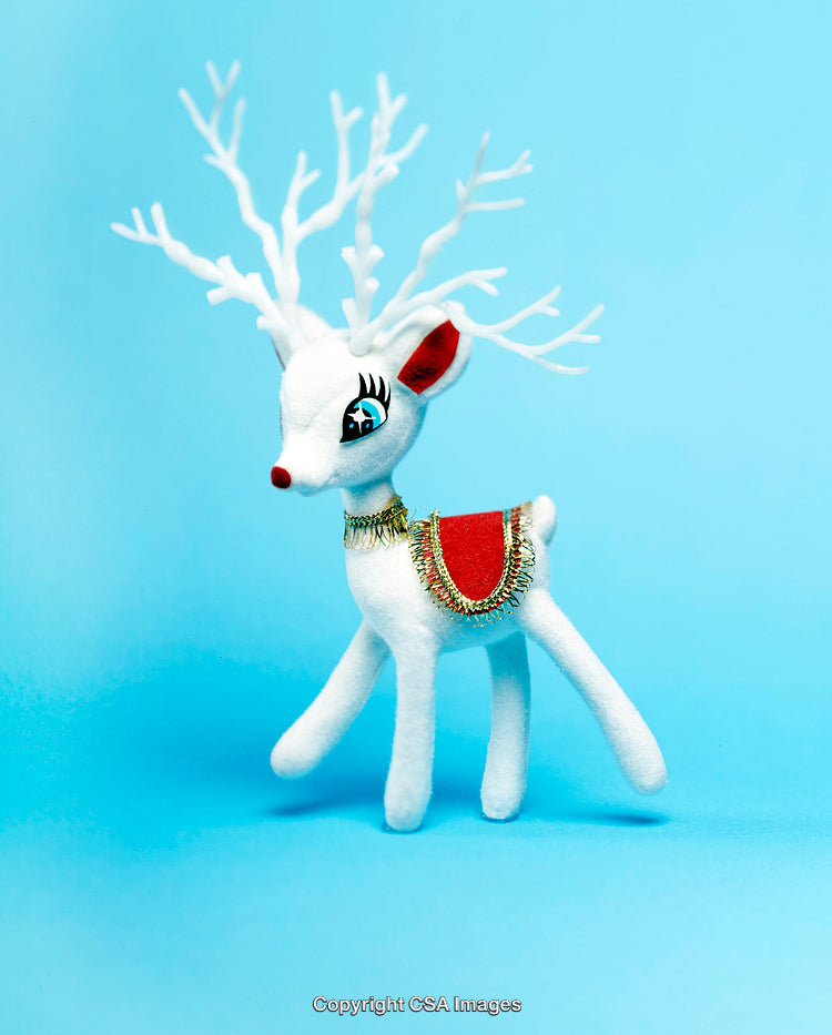 Festive White Reindeer Toy on a Pastel Blue Background