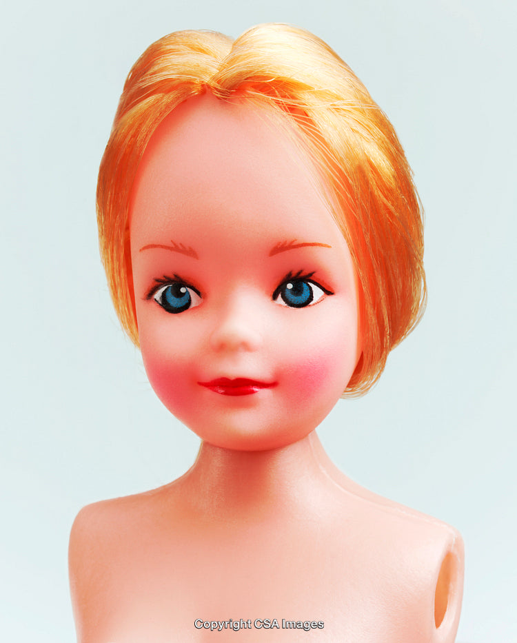 Close-Up Portrait of a Blonde Plastic Doll with Bright Features