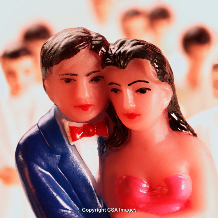 Brightly Colored Plastic Figurines of Dressed-Up Couple
