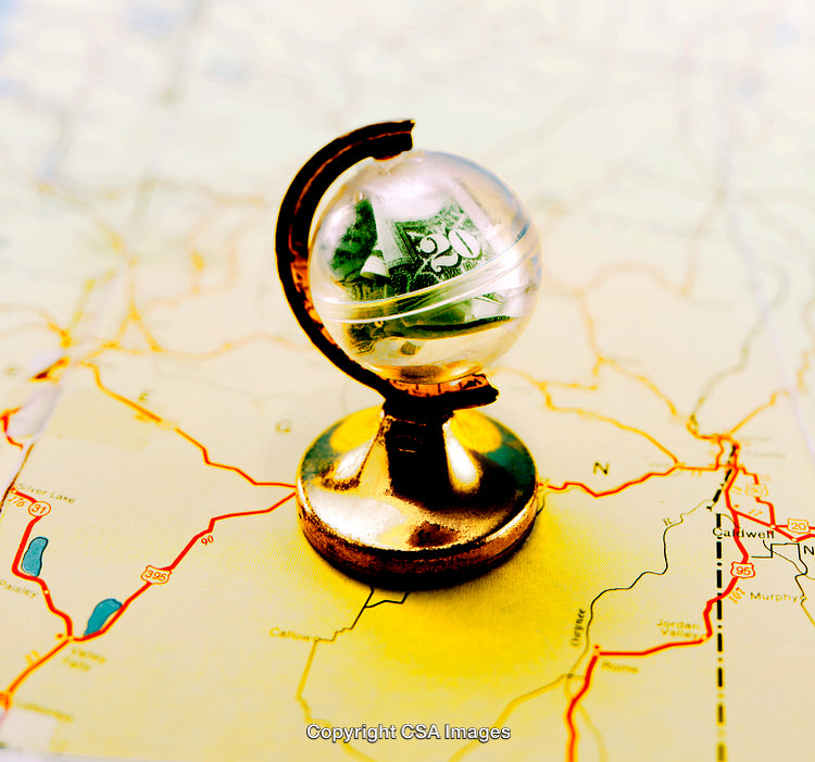 Golden Globe Containing Currency on a Road Map Background