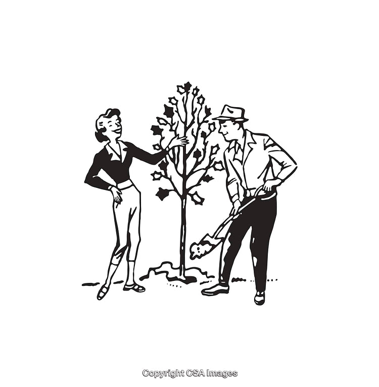 Couple Gardening Together While Planting a New Tree