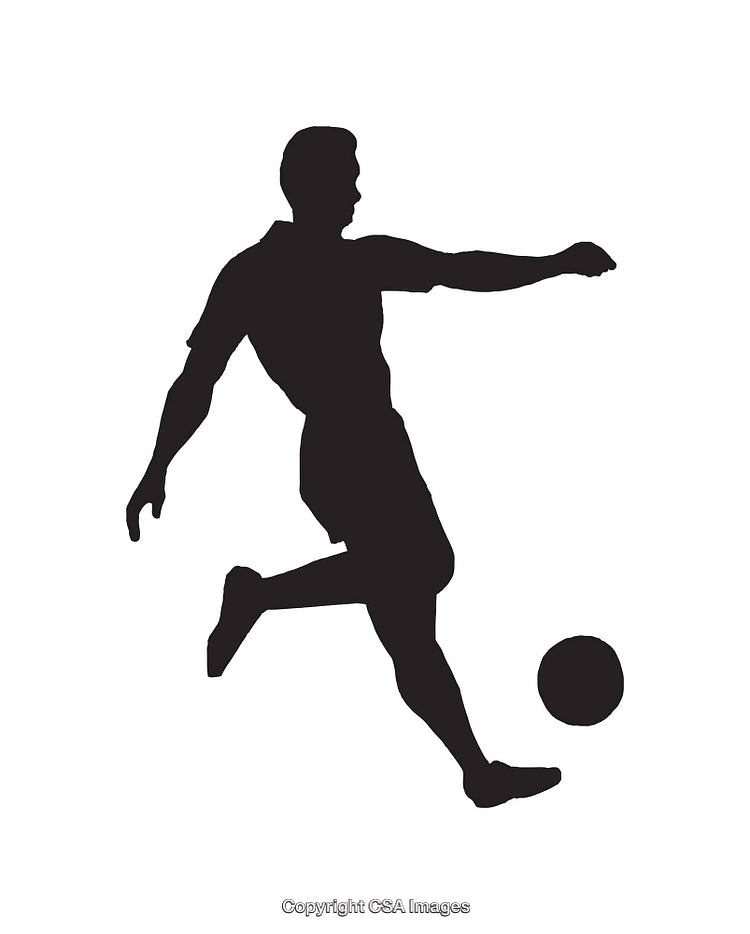 Silhouette of a Soccer Player Kicking a Ball in Motion