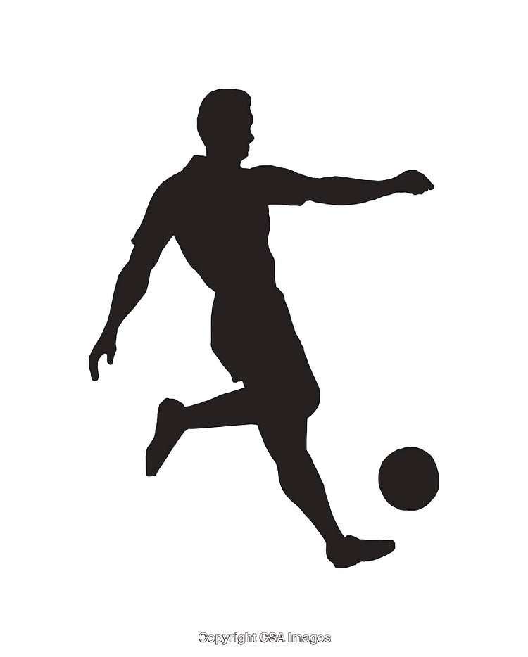 Silhouette of a Soccer Player Kicking a Ball in Motion