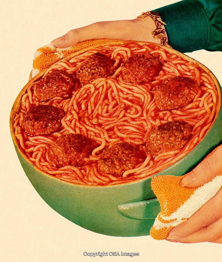 Close-Up of Spaghetti and Meatballs in a Bowl Held by Hands
