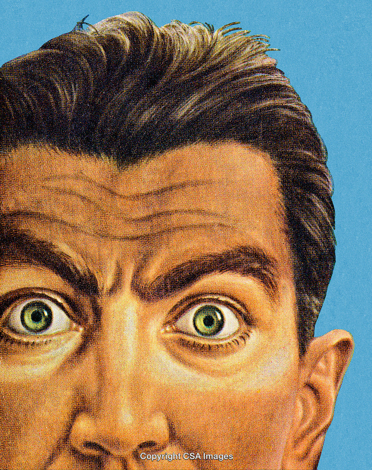 Close-Up of a Surprised Man With Wide-Open Eyes Against Blue Background