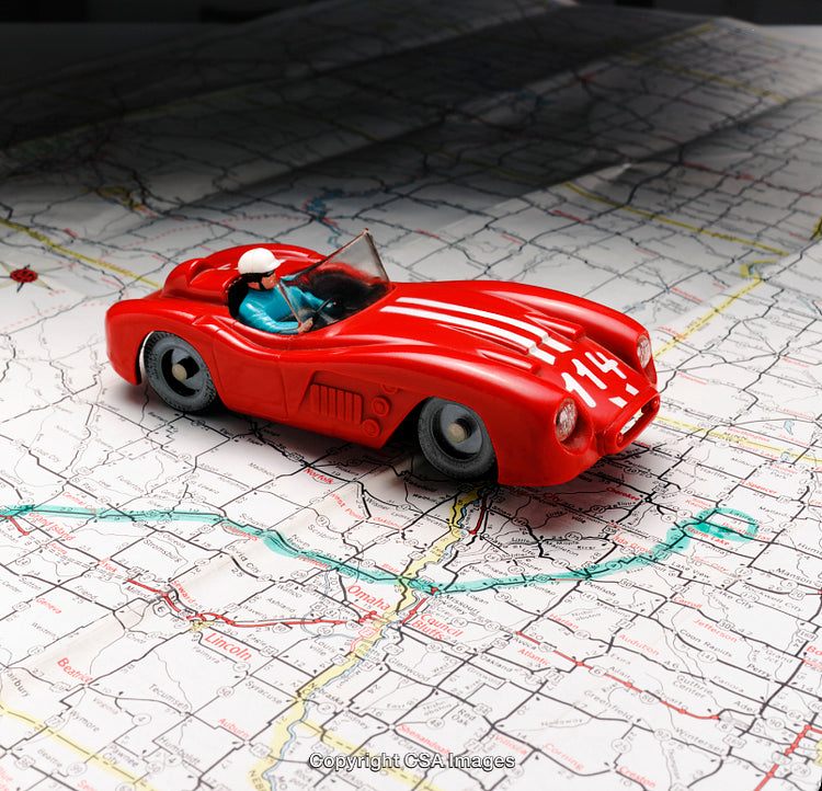 Red Toy Car on a Detailed Map Displaying Travel Representation