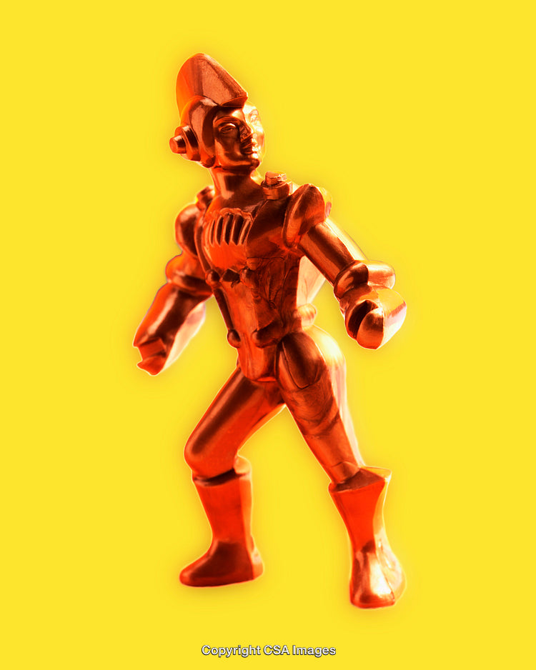 Orange Robot Toy Figure on a Yellow Background in Close-Up View
