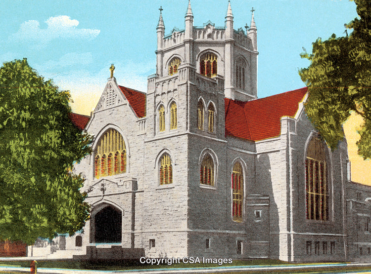 Gothic-Style Church with Red Roof and Tower Amidst Green Foliage