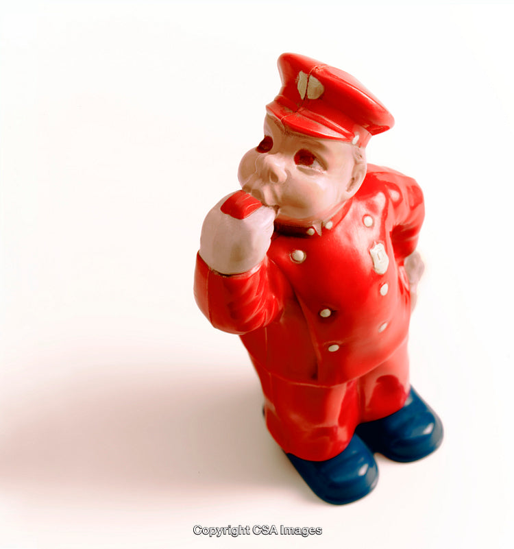 Red Plastic Toy Policeman Figurine on White Background