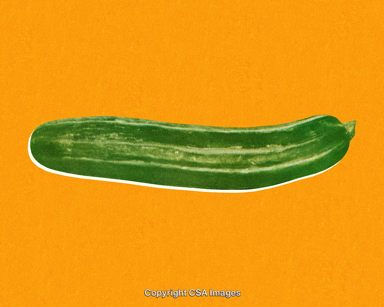 A Fresh Green Cucumber Against a Solid Orange Background