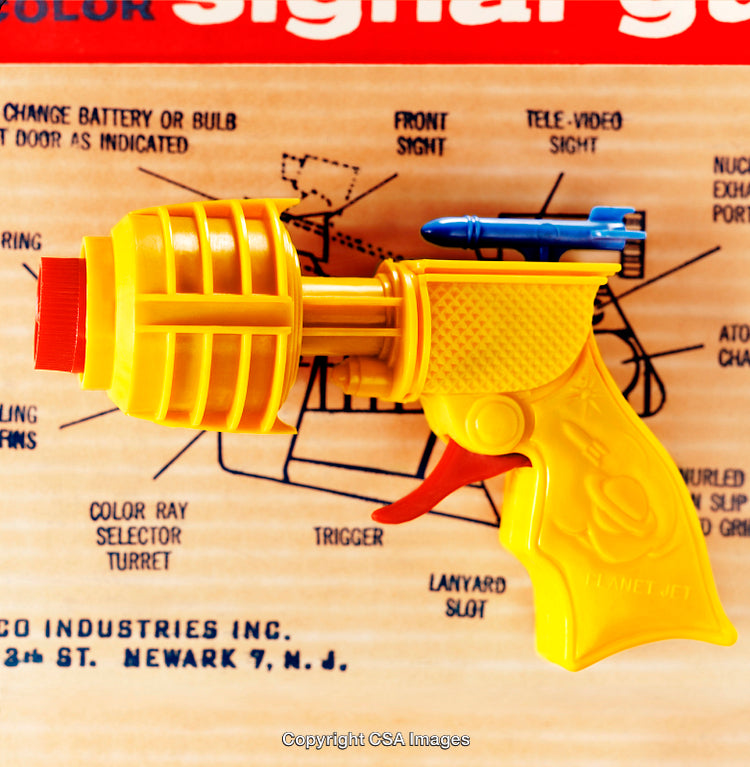 Vintage Yellow Retro Toy Ray Gun on Instructional Background