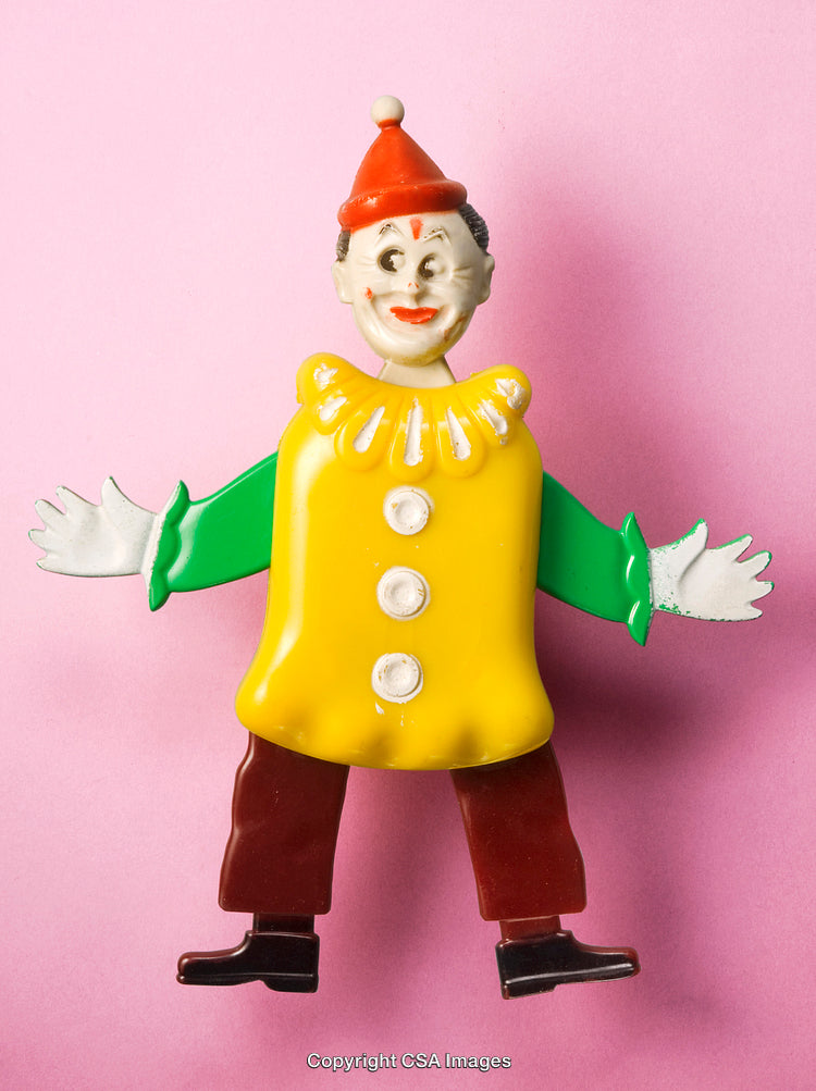 Colorful Vintage Plastic Toy Clown on Pink Background