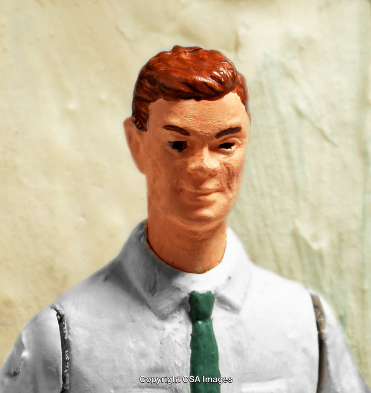 Close-Up of a Hand-Painted Plastic Toy Figurine in Formal Attire