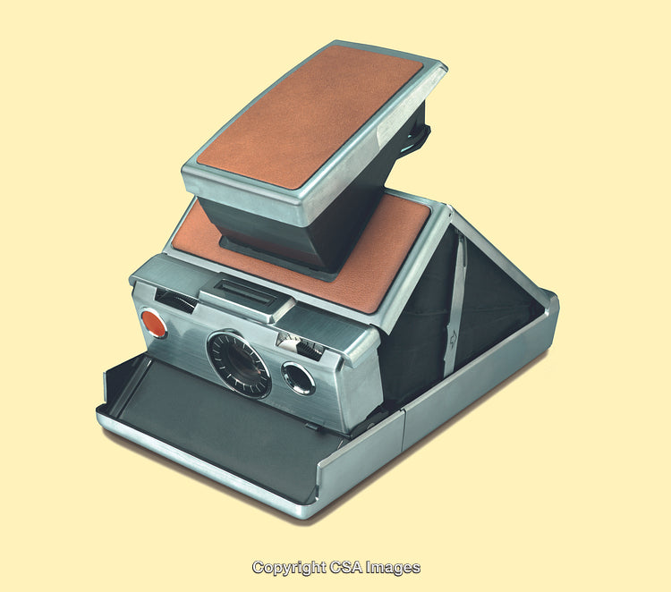 Vintage Retro Camera Featuring Leather and Metal Design on Yellow Background