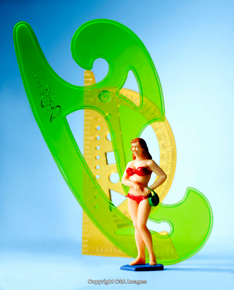 Colorful Plastic Figurine and Geometric Shapes on a Blue Background