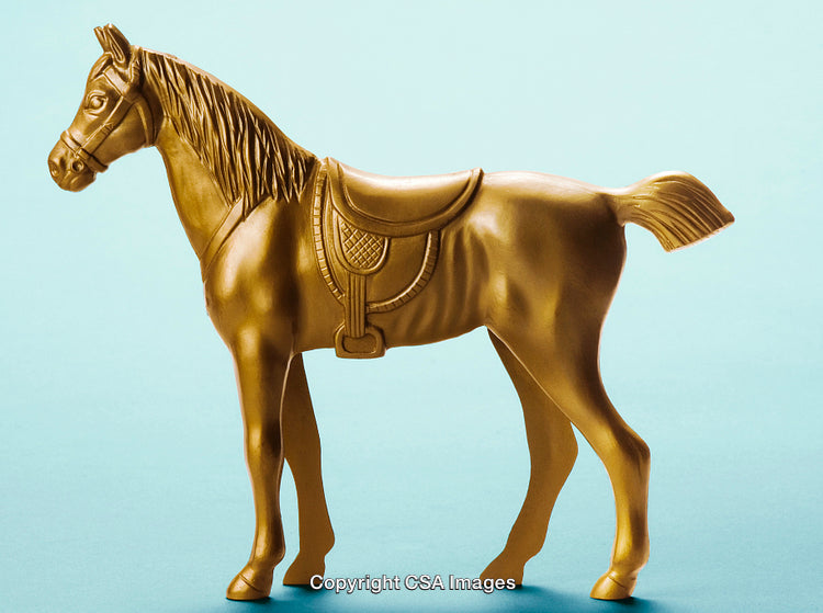 Golden Plastic Horse Figurine on a Light Blue Background