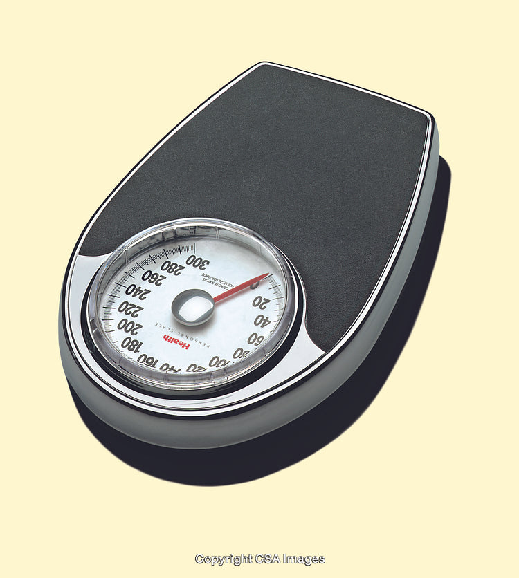 Black Analog Weighing Scale on Light Yellow Background