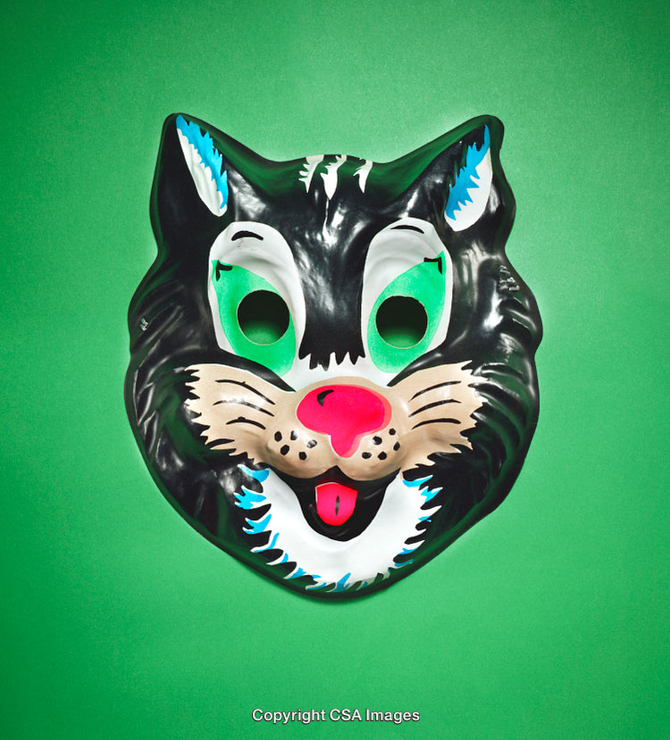 Colorful Cat Mask on Vibrant Green Background Viewed Frontally