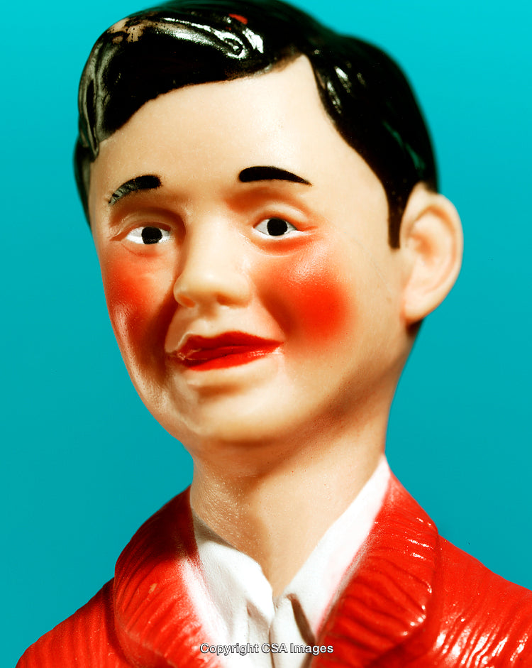 Close-Up of Painted Toy Figure Against Vibrant Background