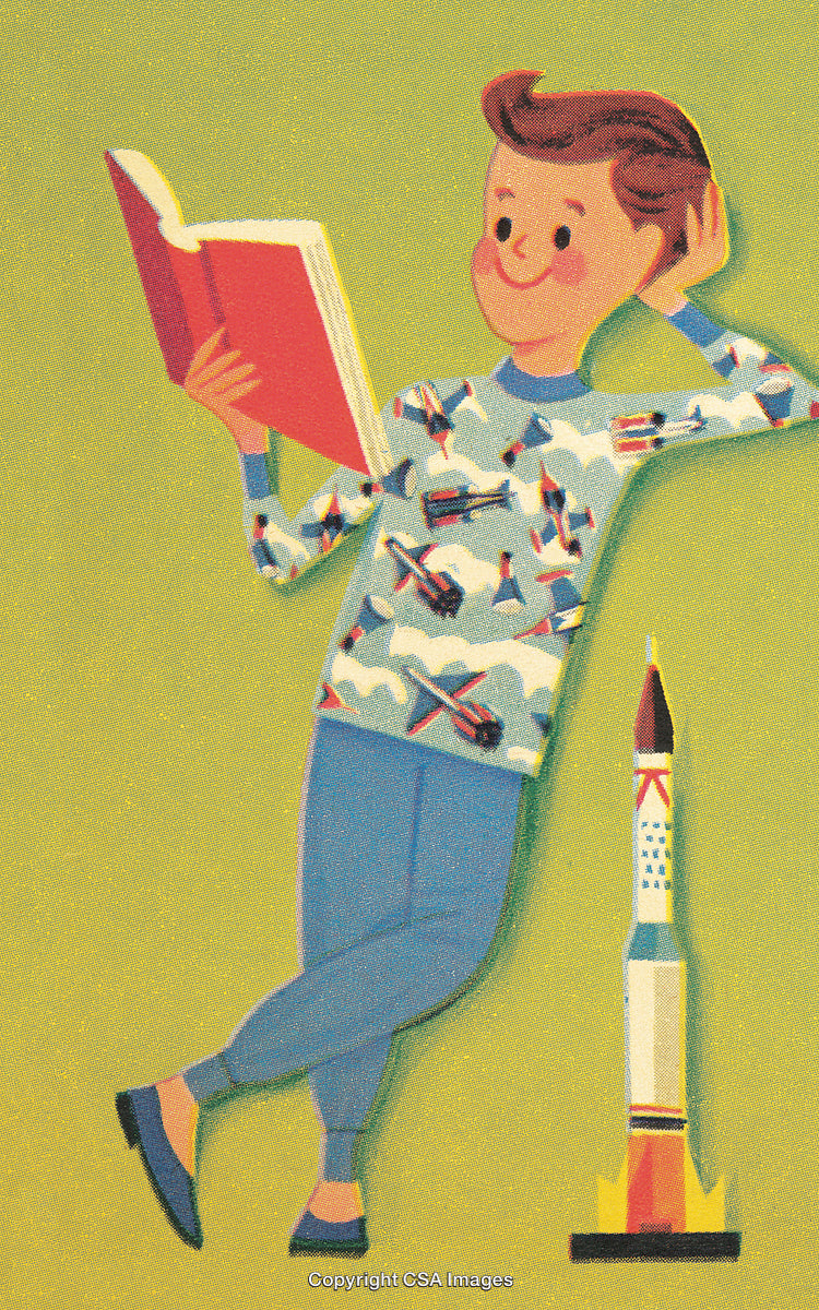 Young Boy Reading a Book While Leaning Near a Rocket Model