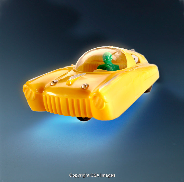 Bright Yellow Futuristic Plastic Toy Car on a Blue Background