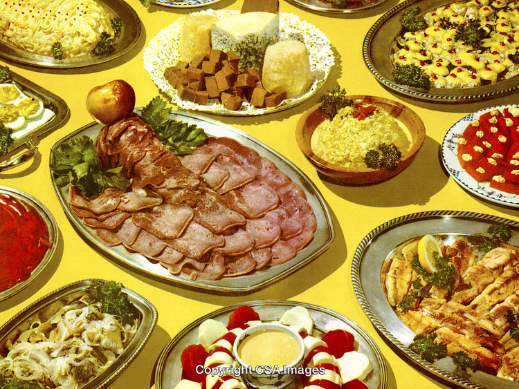 Variety of Retro-Style Party Foods Arranged on Colorful Platters With Cheese and Meats