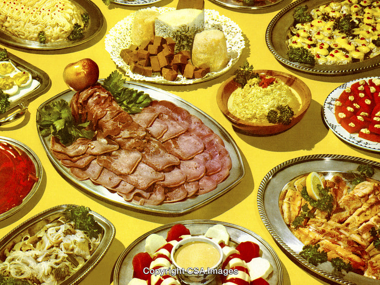 Variety of Retro-Style Party Foods Arranged on Colorful Platters With Cheese and Meats