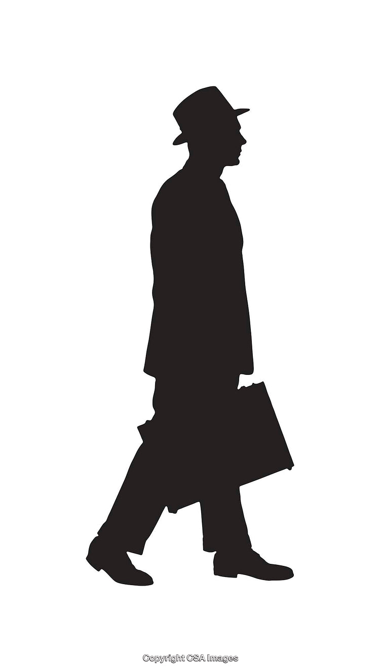 Silhouette of a Businessman Walking With a Briefcase in Profile View