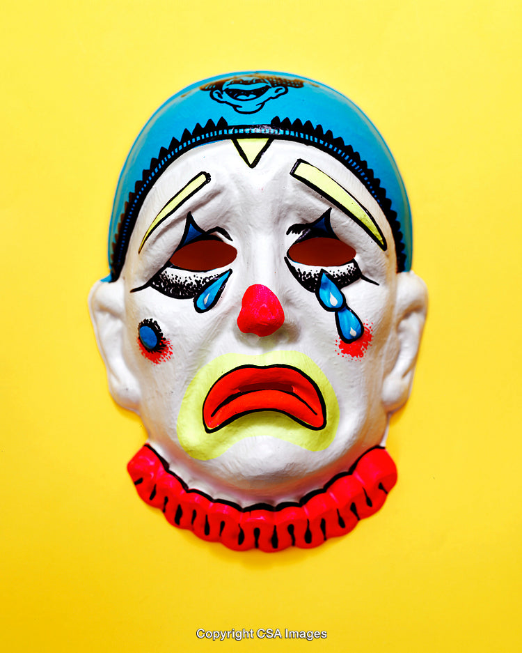 Colorful Sad Clown Mask on Vibrant Yellow Background