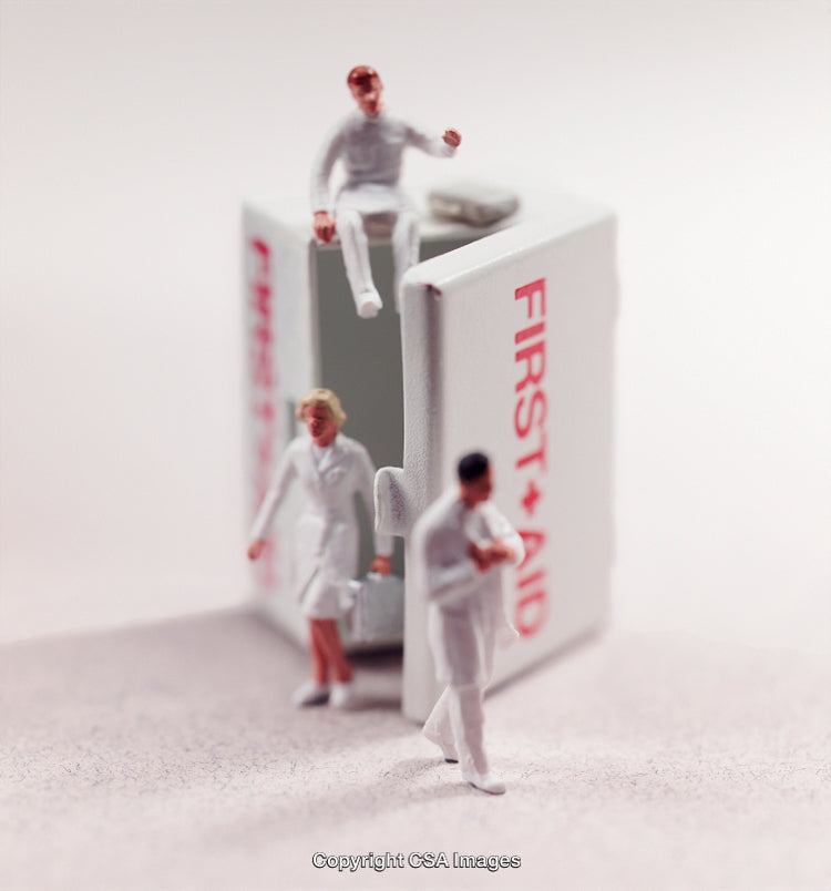 Tiny Medical Figures with First Aid Kit in Artistic Concept