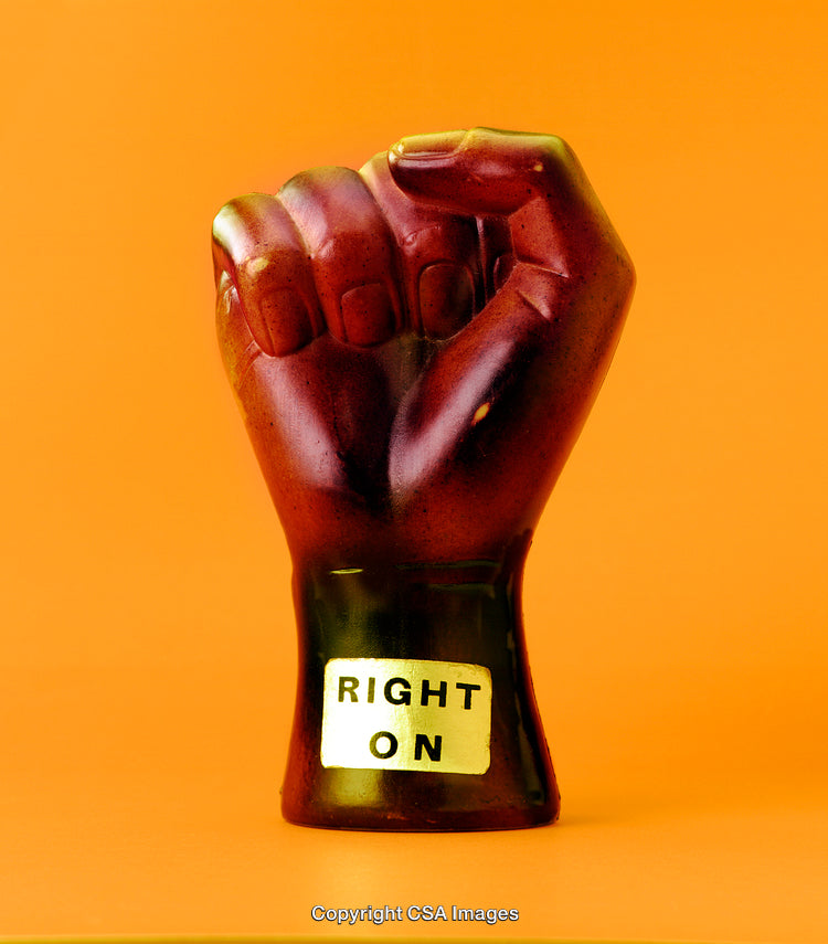 Ceramic Fist with Inspirational Message Against Vibrant Orange Background
