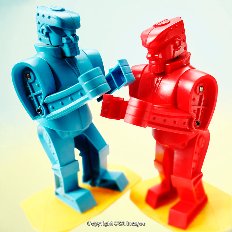 Red and Blue Robot Toys Engaged in Playful Interaction