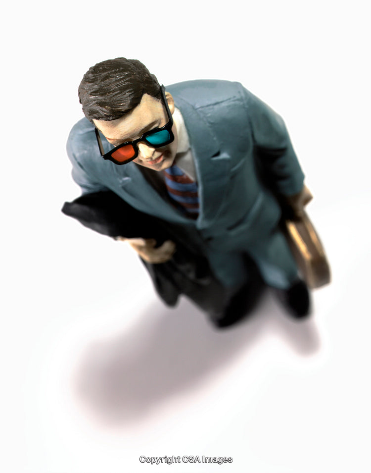 Top View of Businessman Figurine Wearing 3D Glasses Carrying Briefcase