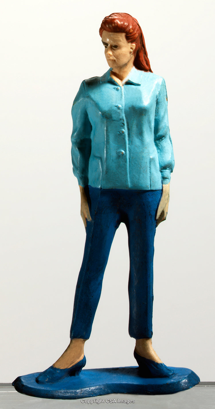 Small Figurine of a Woman Standing on a Blue Surface